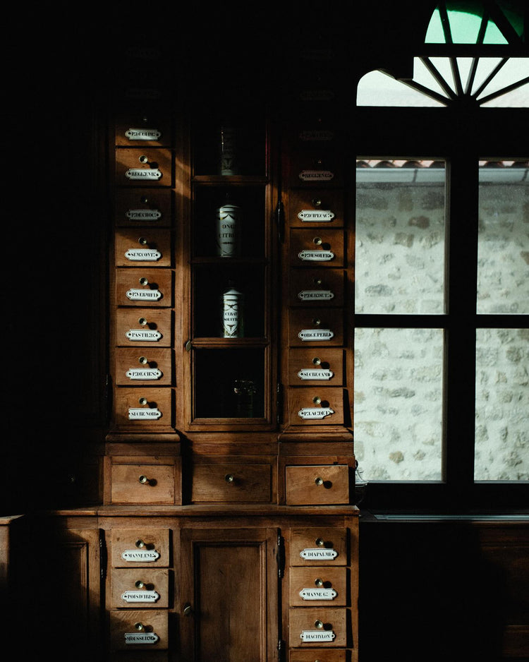 Light falling on the drawers and jars of the Hôtel-Dieu apothecary.